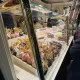 Anwendungsbeispiel am Weihnachtsmarkt-S��warenstand: Hustenschutz/Spuckschutz Modell 20-120-25 mit Messing-Gold Pfosten (links) und senkrechter Glasabtrennung. Ideal f�r hygienische Ausgabe von Schokolade, S��waren und offenen Lebensmitteln.